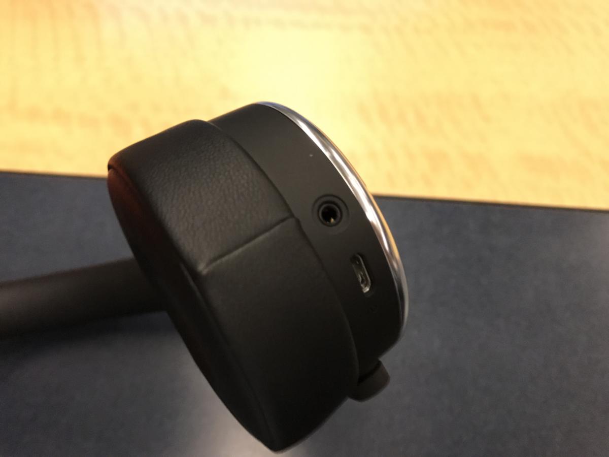 The bottom of the left ear cup has a microUSB charging port and analog input.
