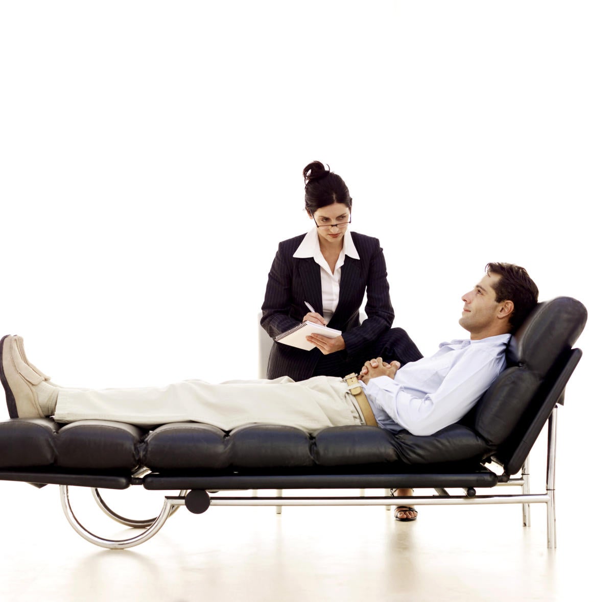 Man laying on psychiatrists couch getting therapy