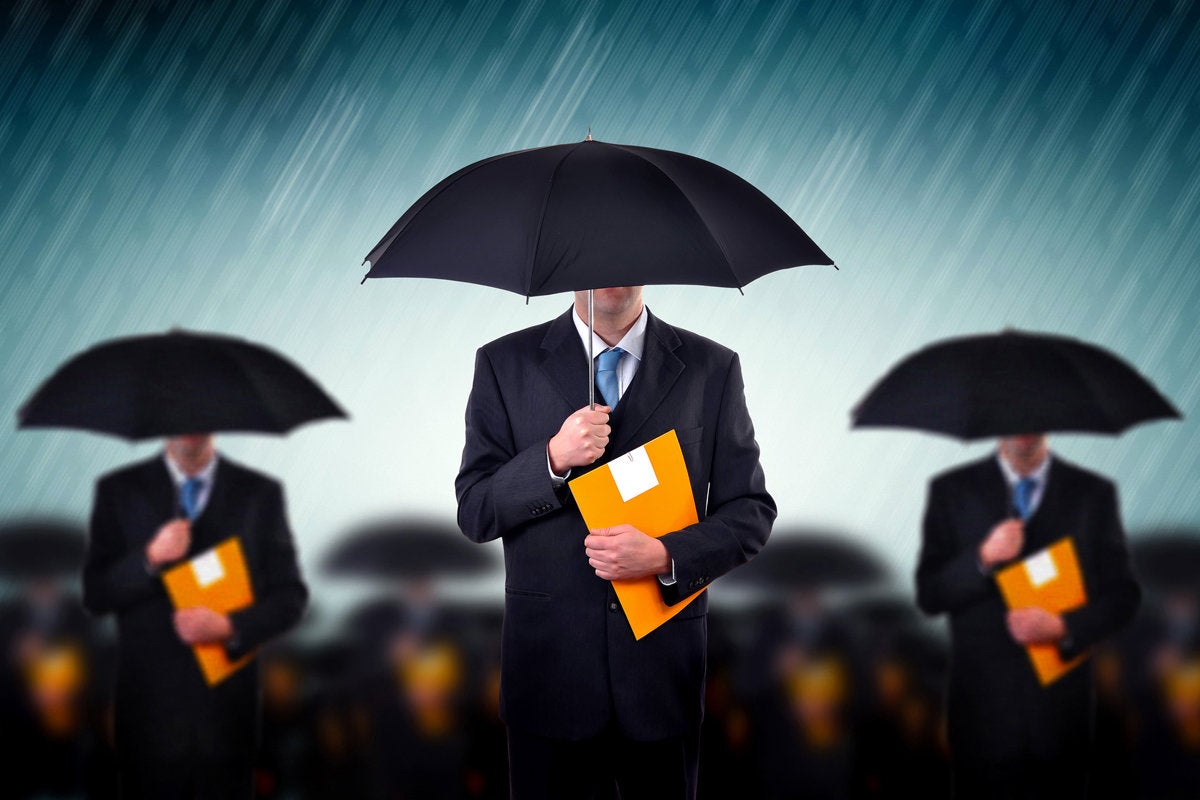 businessmen with umbrellas risk protected storm