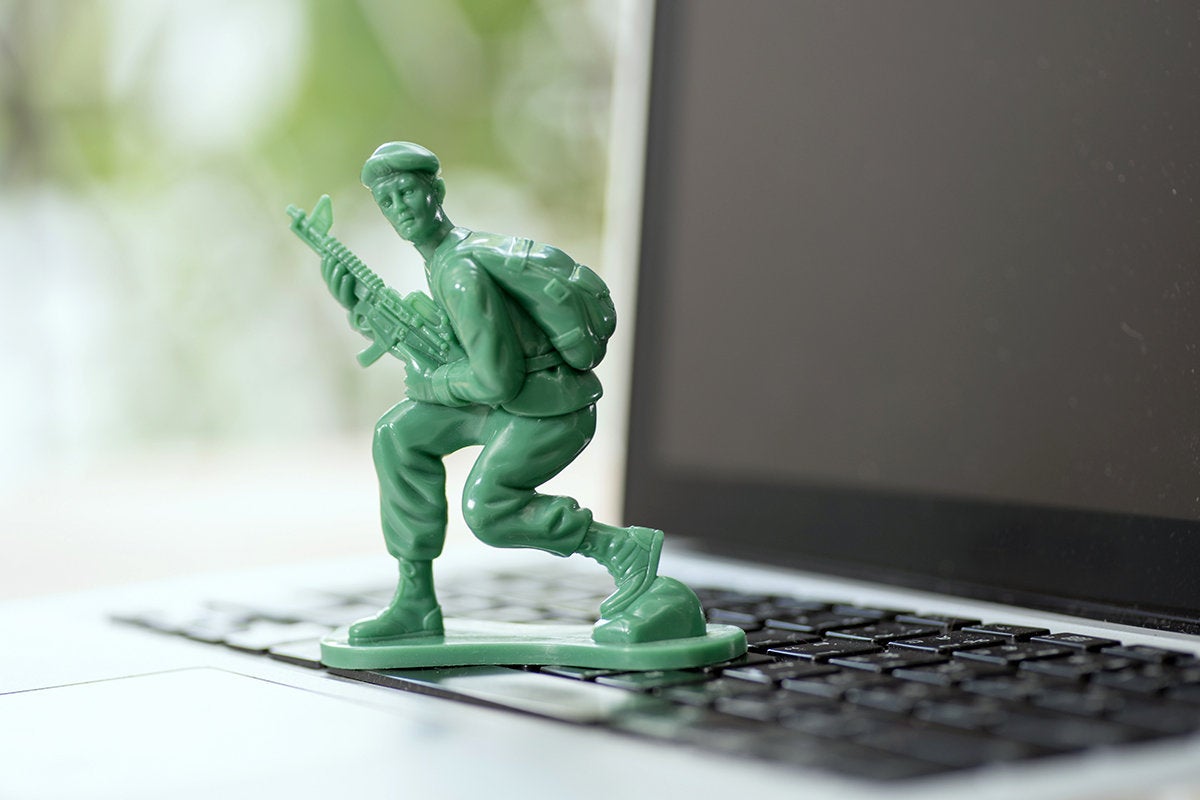 green army soldier on a laptop keyboard