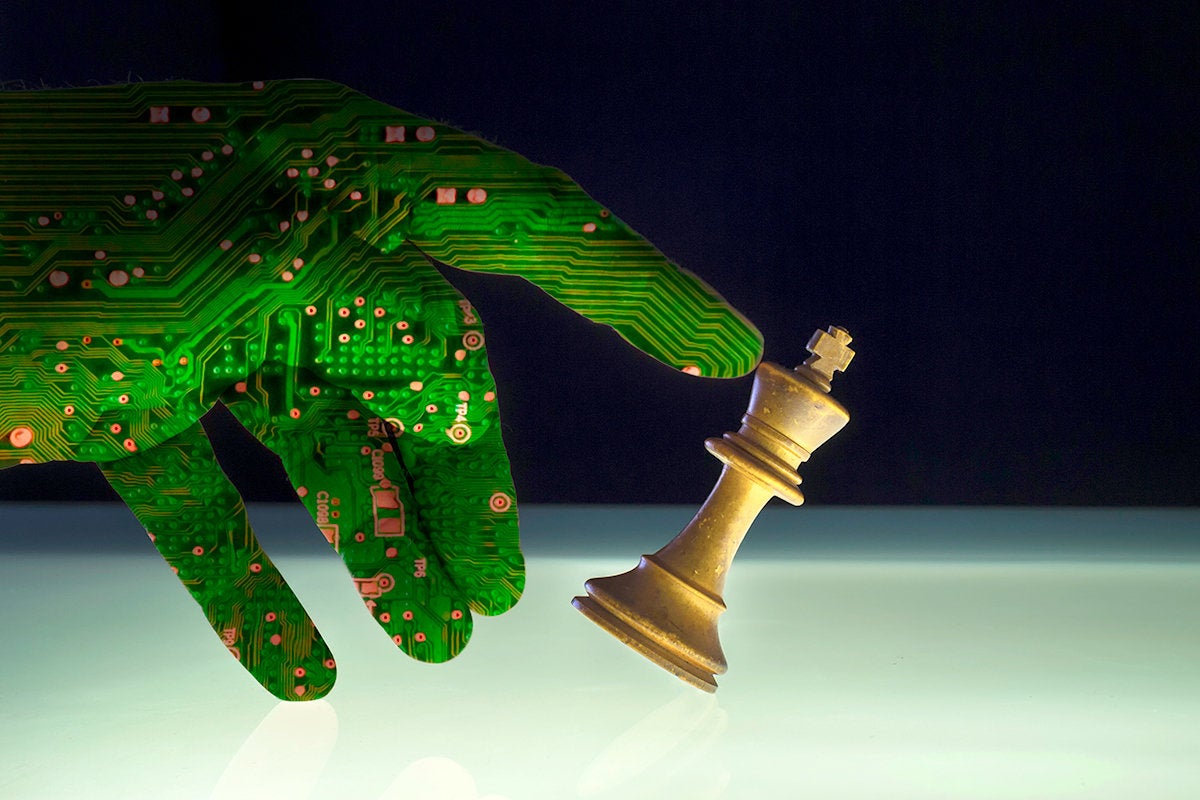 security threat - circuit board-hand knocking over a chess piece