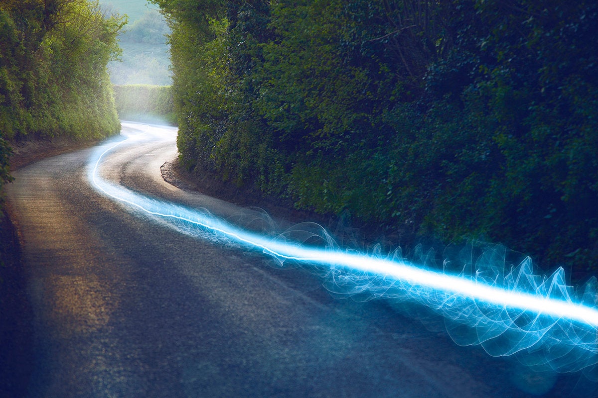 blazing speed leaving a glowing trail along a road
