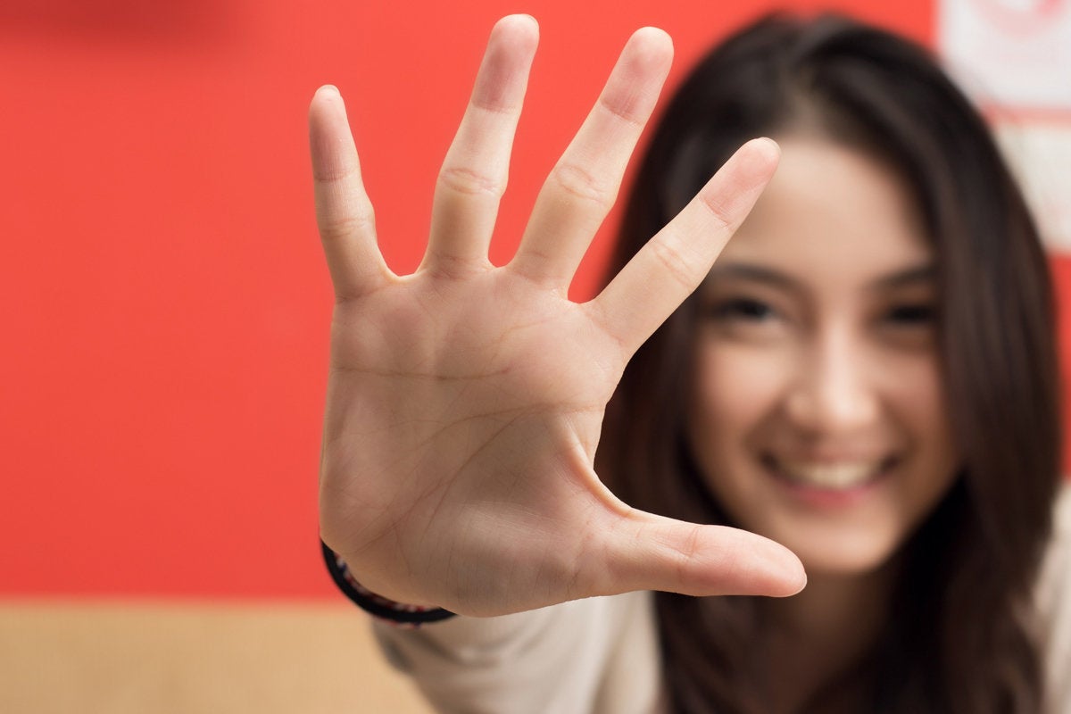 woman holding up 5 fingers number 5 top five