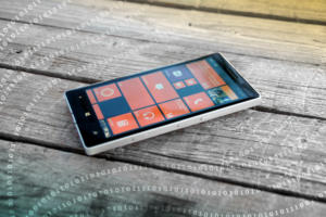 Binary code surrounds a Nokia Lumia mobile phone running Microsoft Windows