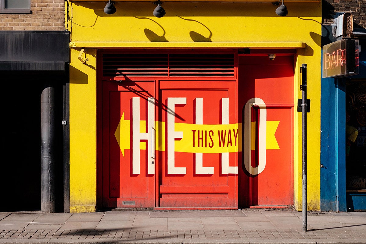 sign: hello, this way - welcome