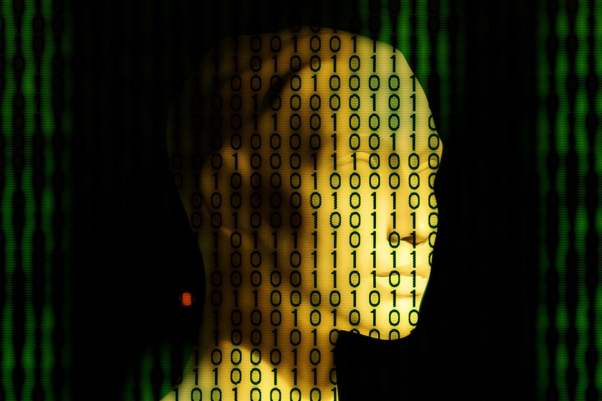 binary code displayed across an artificial face