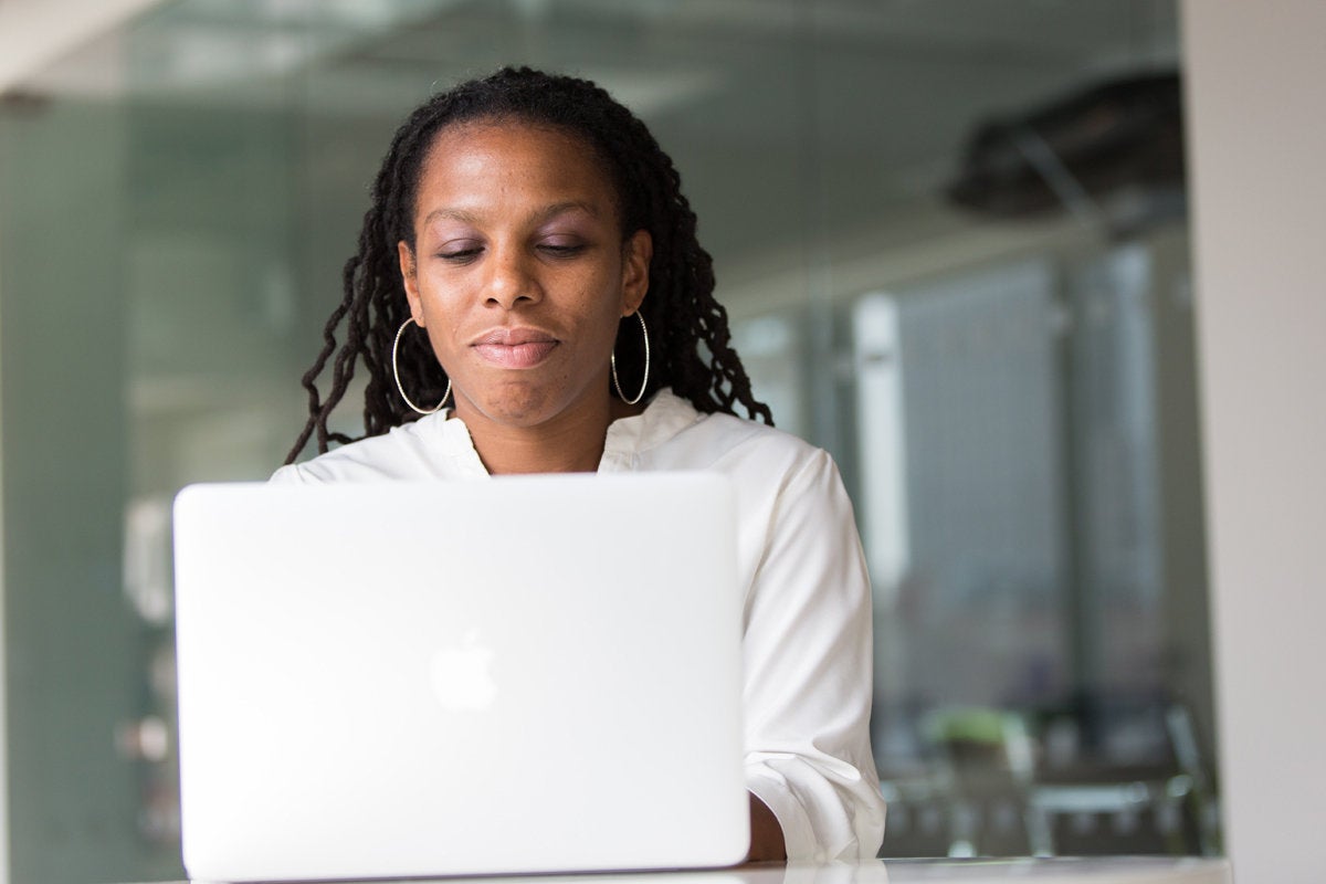 african american woman on laptop mac diversity gender equality programmer devops by christina morillo 100764670 large