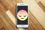 angry face emoji on mobile phone
