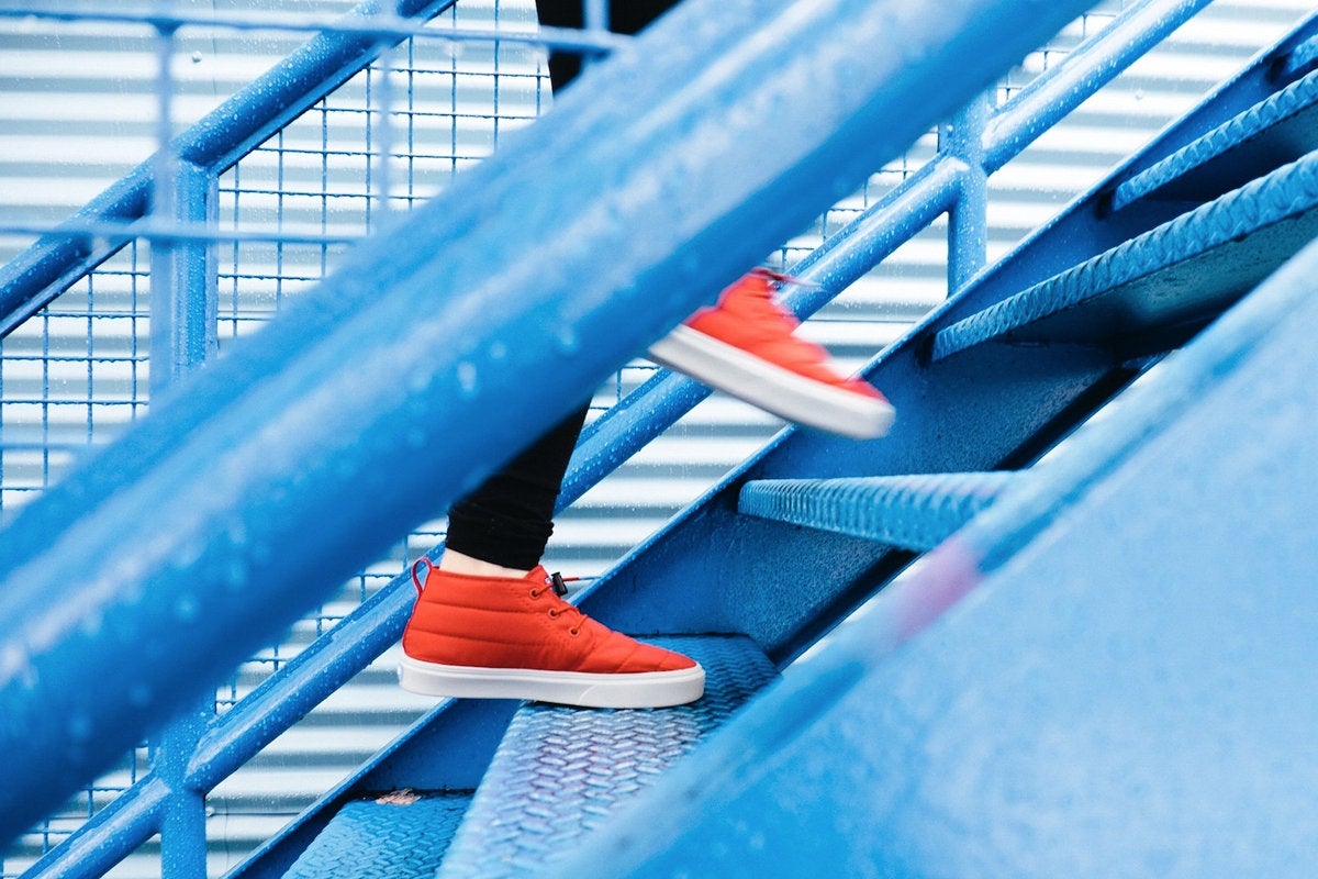 career growth leader equality corporate ladder stairs orange sneakers by lindsay henwood unsplash