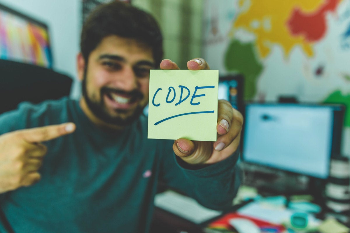 man holding code sign programmer developer devops data scientist tech roles hitesh choudhary via un