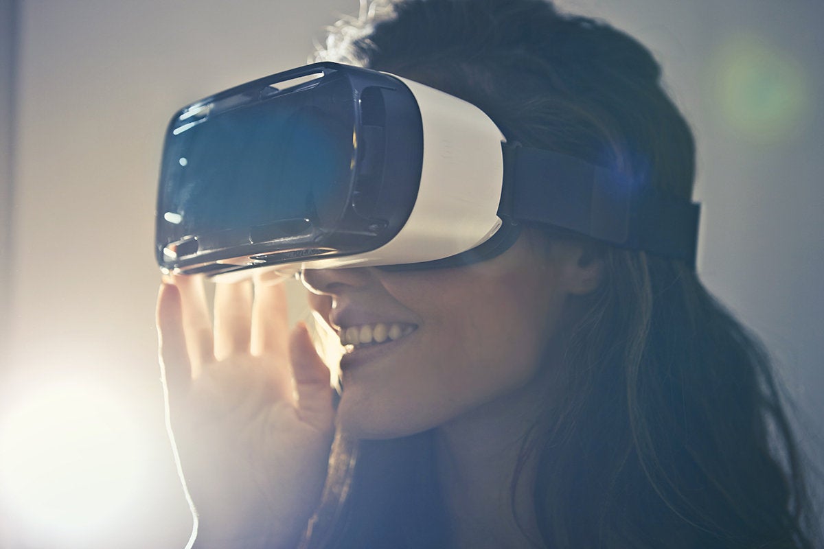A woman wearing a virtual reality [VR] headset.