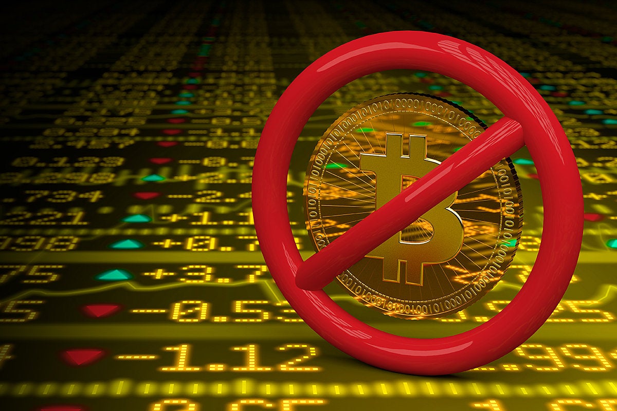 Bitcoin banned against a background of stock wall trading data.