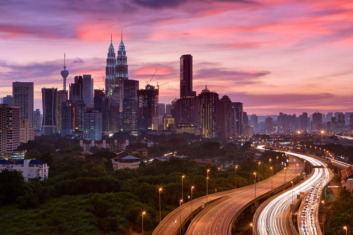 Kuala Lumpur skyline and traffic light trails at dusk, Malaysia, Southeast Asia