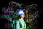 Industry 4.0 / Industrial IoT / Engineer reviews virtual interface for robotics.