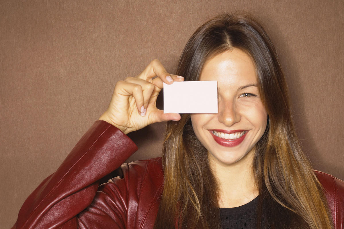 woman with business card resume networking confident