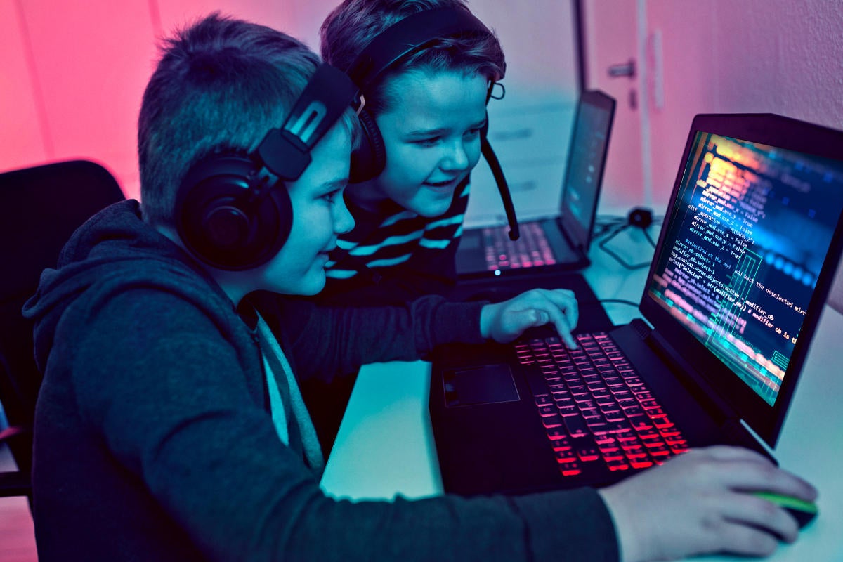 child coder boy with computer gaming children laptop