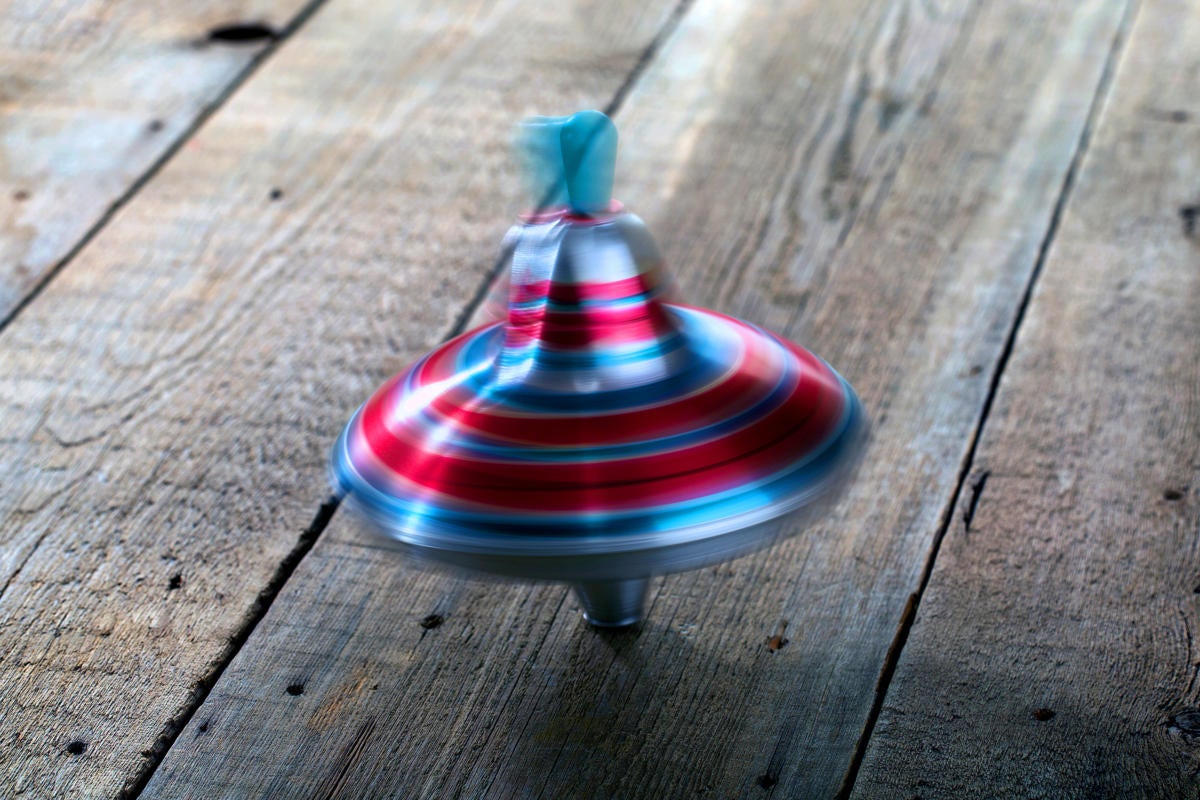 Spinning top on a wooden floor.