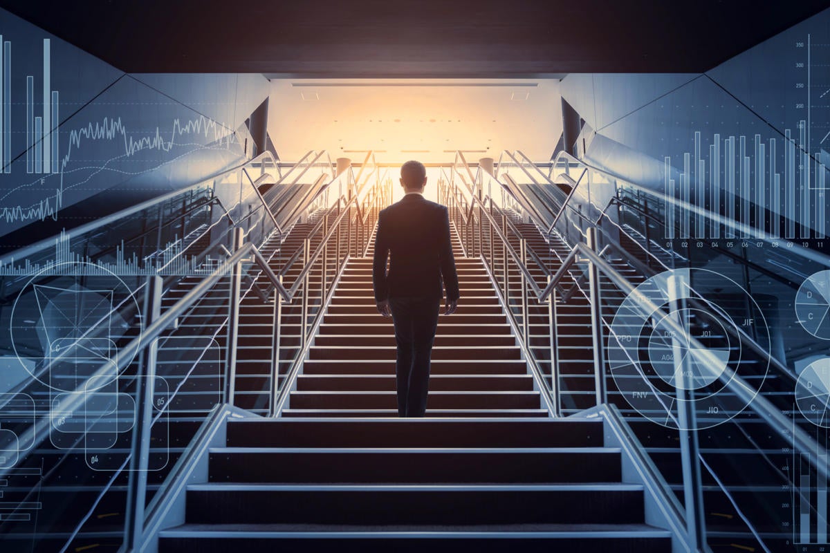 A businessman ascends a staircase surrounded by symbols of business and business data.
