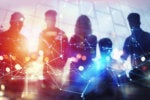 Blurred silhouettes amid abstract technology.