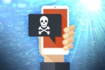 SMS phishing / smishing  >  Mobile phone displays text bubble with skull + crossbones