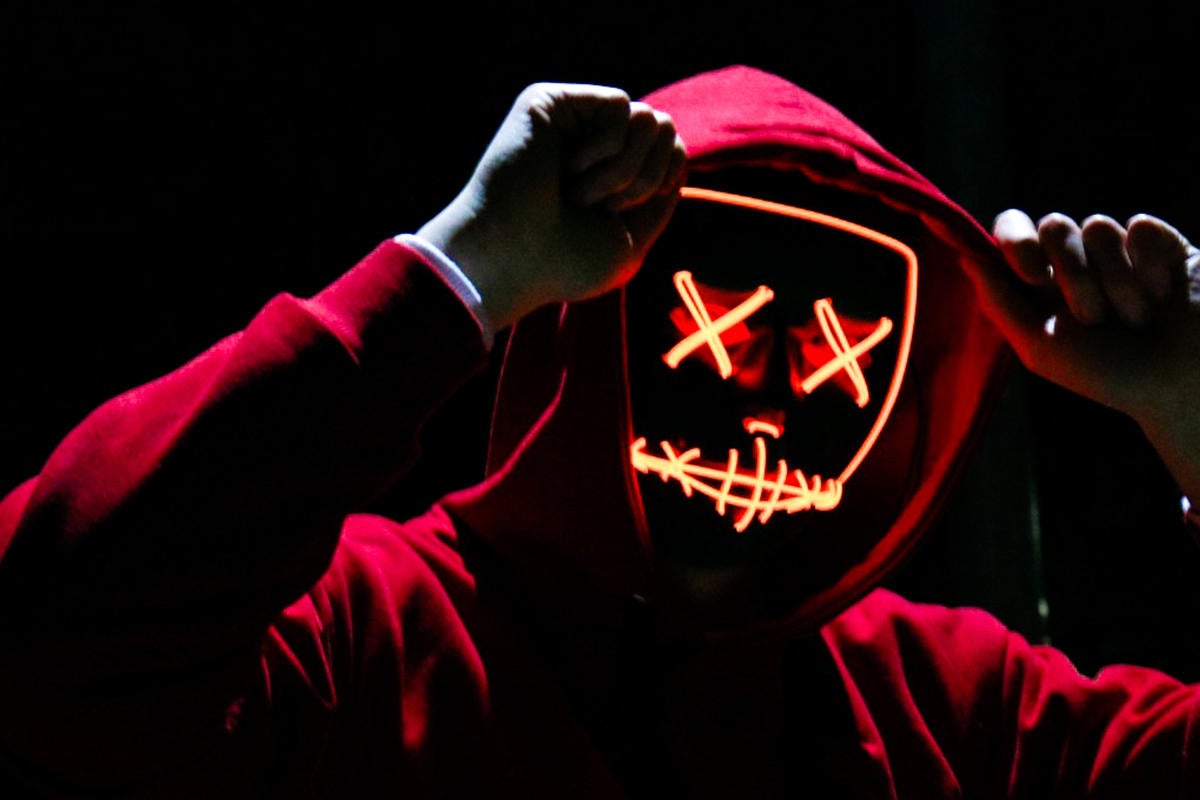 social engineering fraud impersonation neon face with hoodie by photo by sebastiaan stam on unsplash