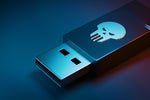 Malicious USB dongle / memory stick / thumb drive with skull icon