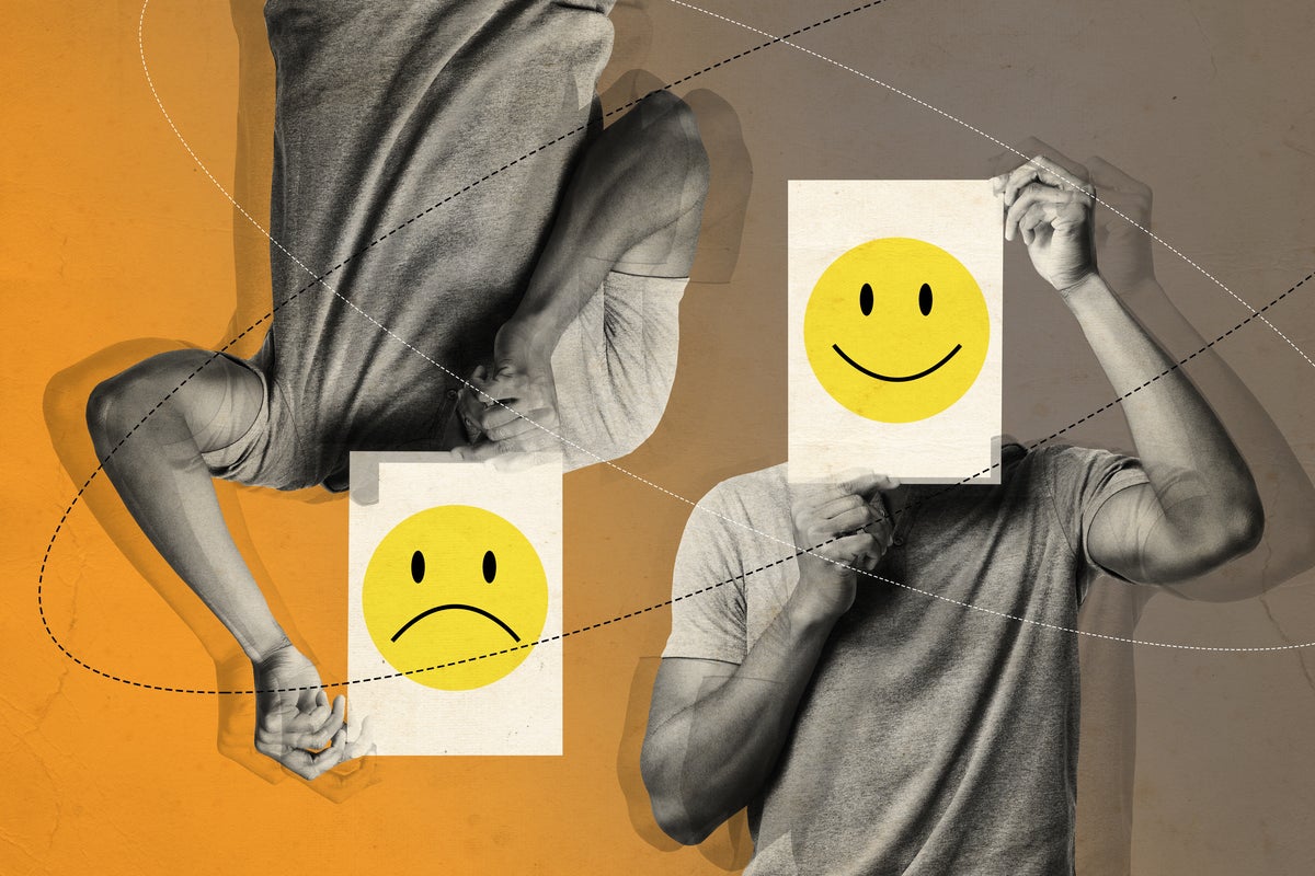 smiley face happy and sad man holding smiley face on paper over face by prostock studio getty images