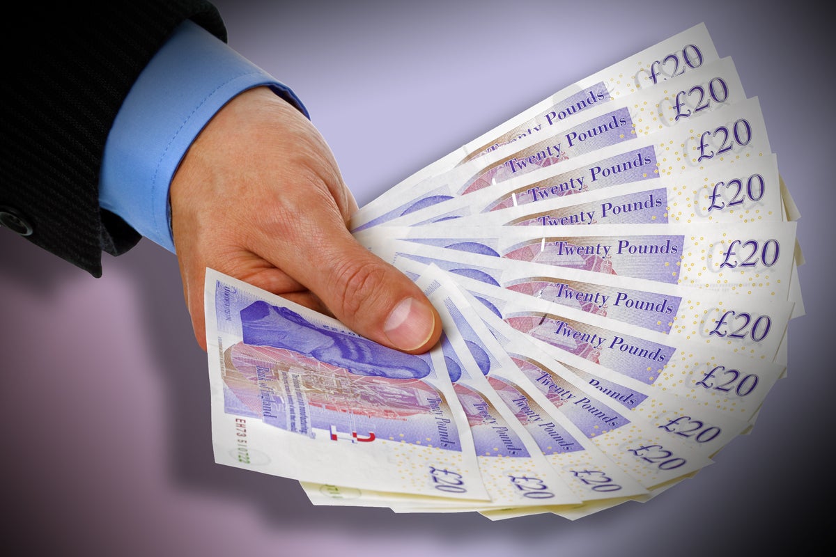 man holding fanned bills british pounds currency bank notes by brianajackson getty images 137847250