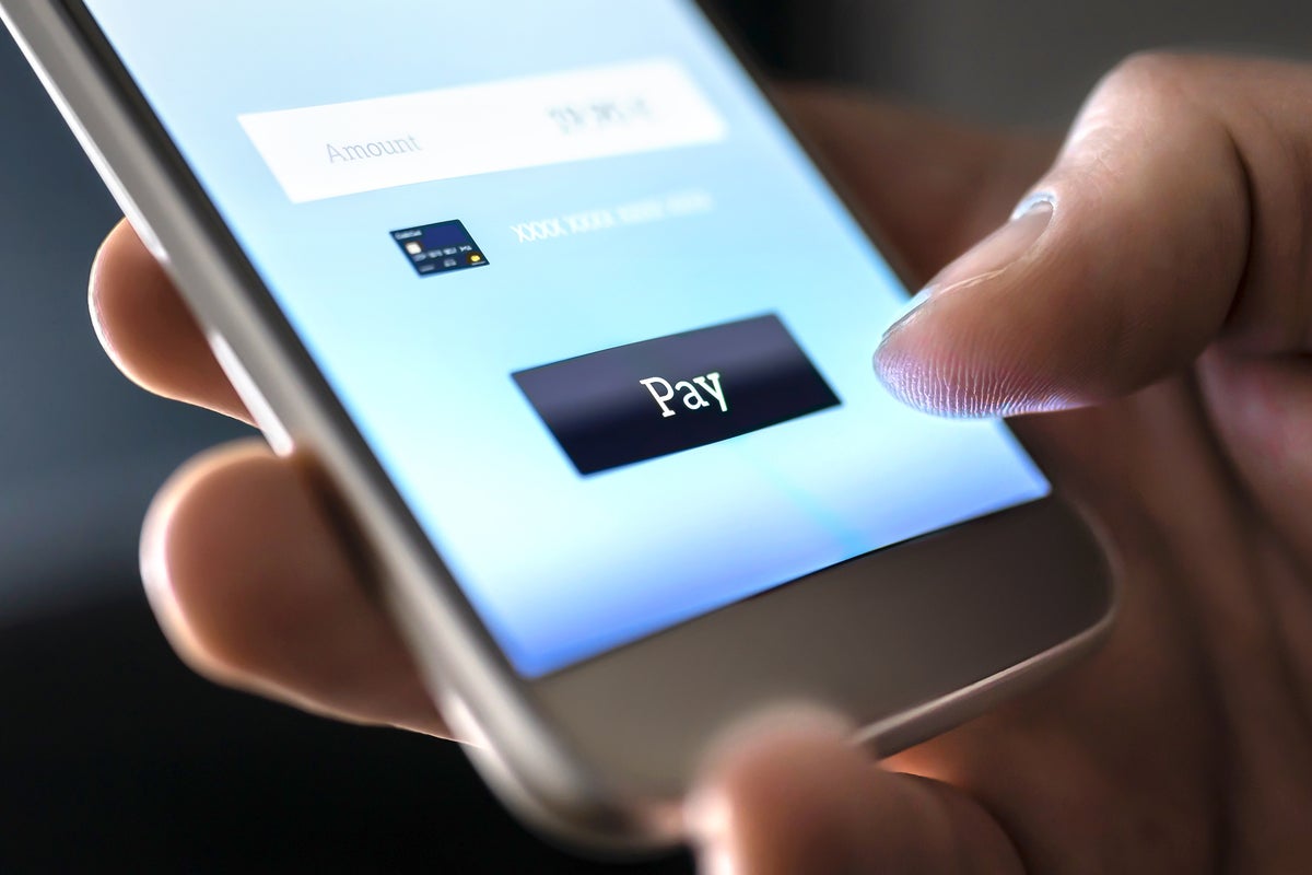 A credit card payment is made on a mobile phone via digital wallet.