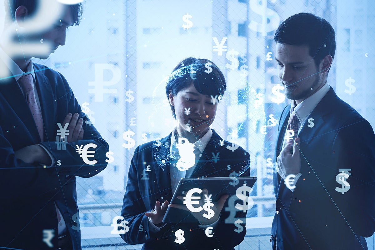 An abstract network of currency symbols overlays a team of three in discussion.