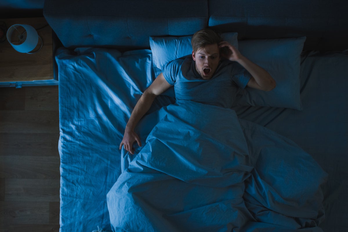 man in bed nightmare what keeps you up at night stress sleeping by gorodenkoff getty images