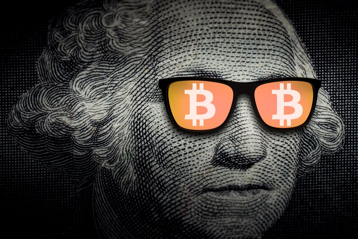 The U.S. hundred-dollar banknote's George Washington wears glasses with bitcoin logos.
