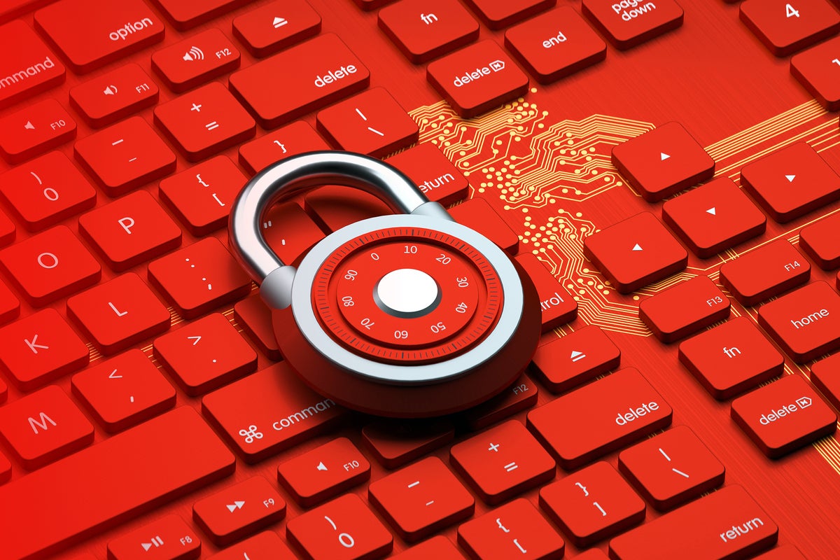 A red padlock sits on a red keyboard and golden circuit background.