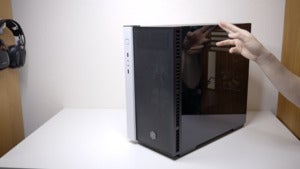 Silverstone Redline RL08 exterior shot with hand pointing at tempered glass side