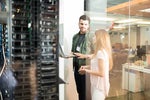 IT professionals converse in a network server room / data center.