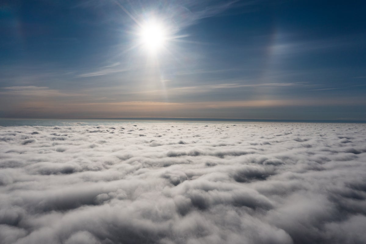 sunrise on blue sky. View over the clouds.