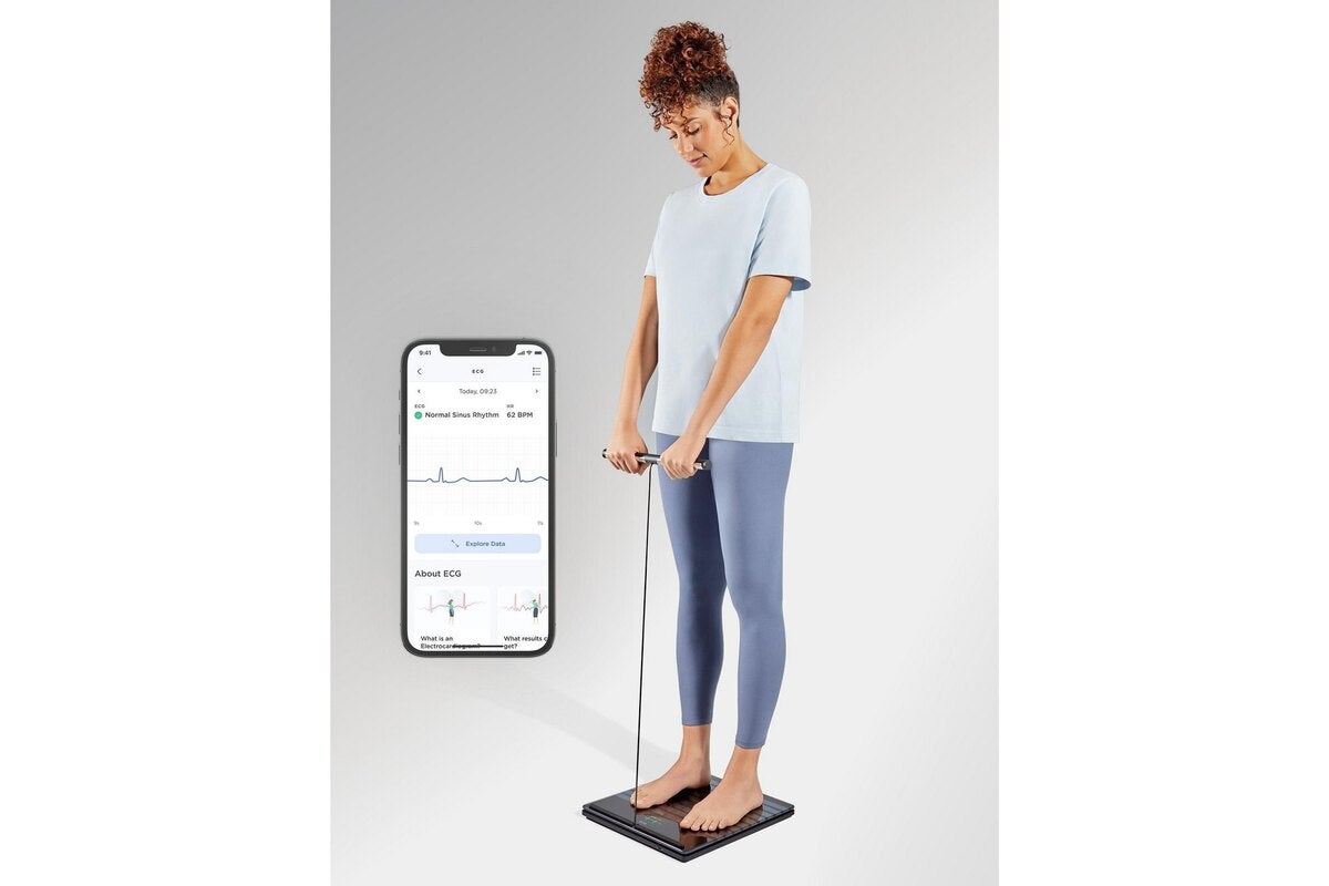 withings body scan woman on scale vertical photo