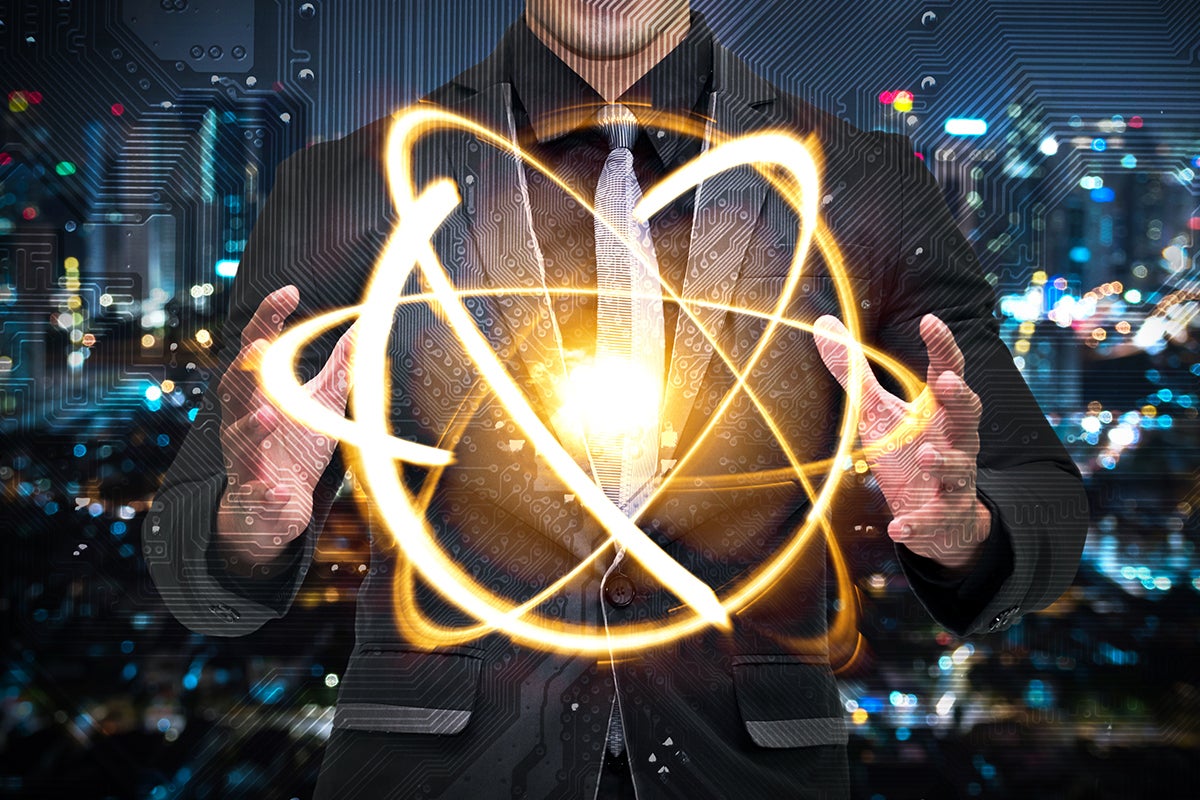 Quantum computer technology concept, man in suit holding shining yellow cosmic orb