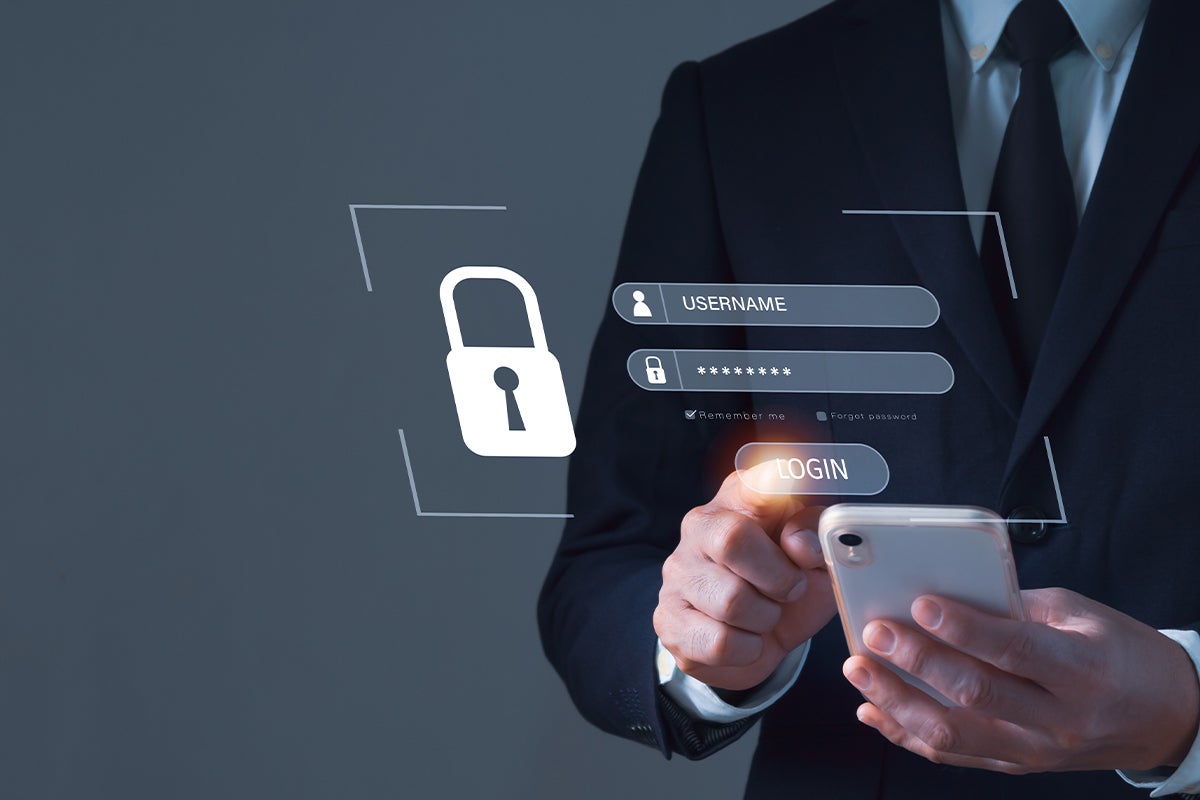 Businessman on mobile phone logging in to secure account