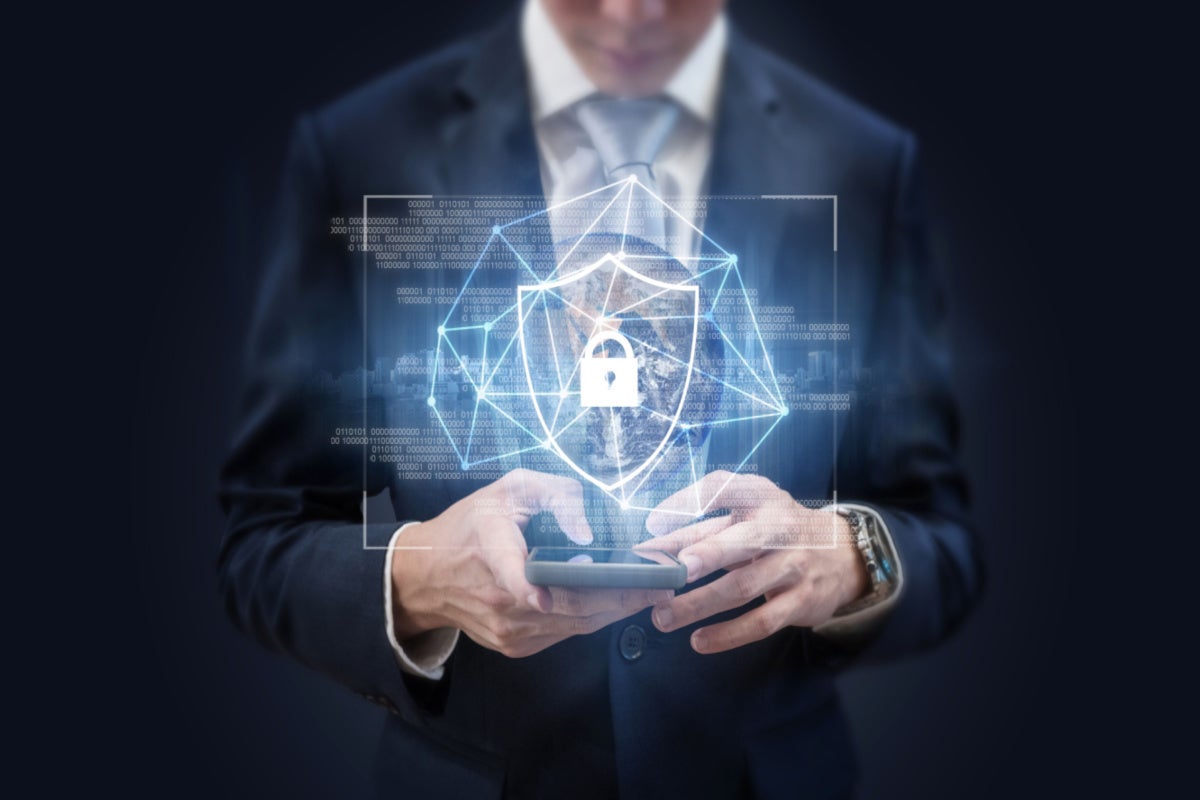 Businessman using mobile smart phone and security shielding icon.