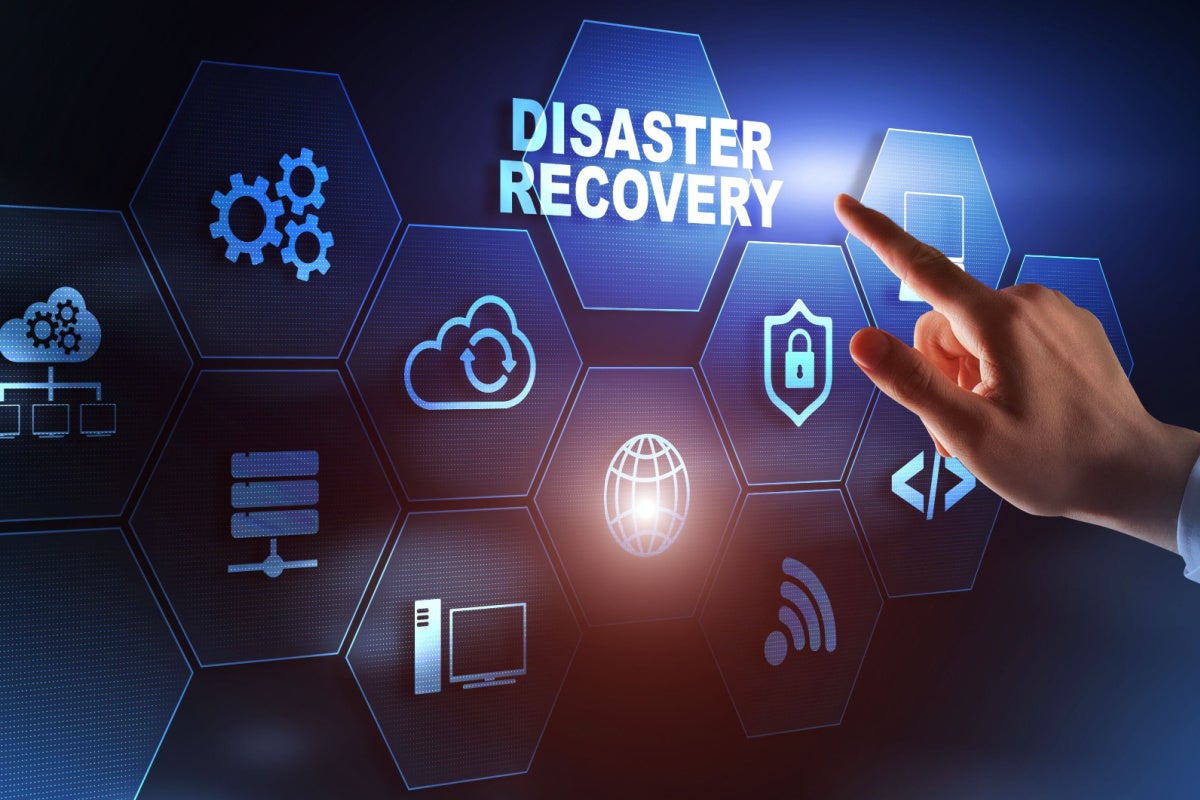 Businessman pressing disaster recovery on virtual screen