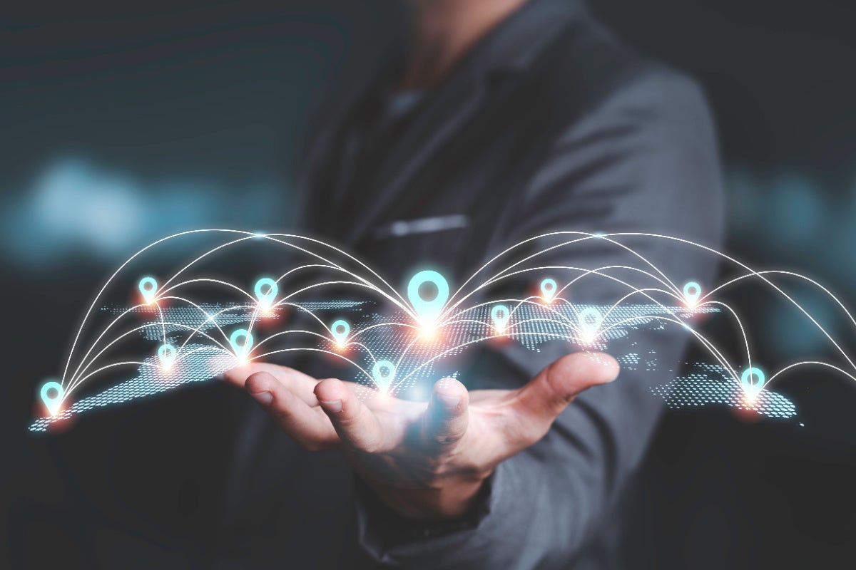 Businessman holding virtual network in his palm
