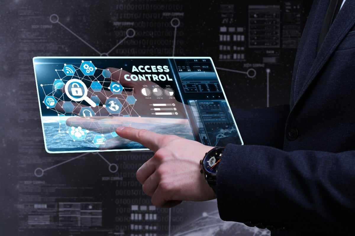 Young businessman working on a virtual screen with the inscription: access control