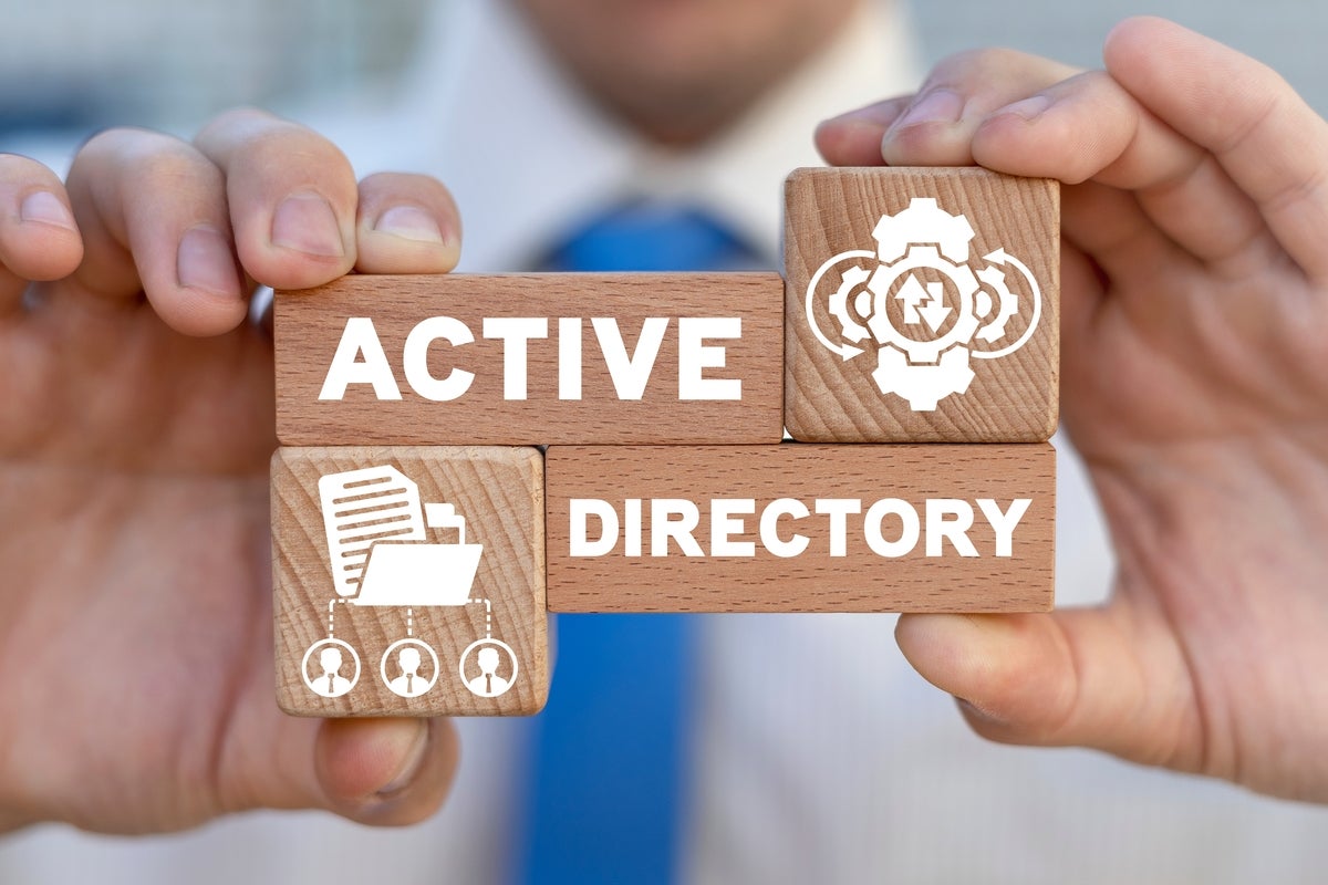 Businessman holding wooden blocks that say 'Active Directory'