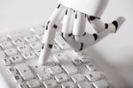 ChatGPT R, robotic hand typing on keyboard