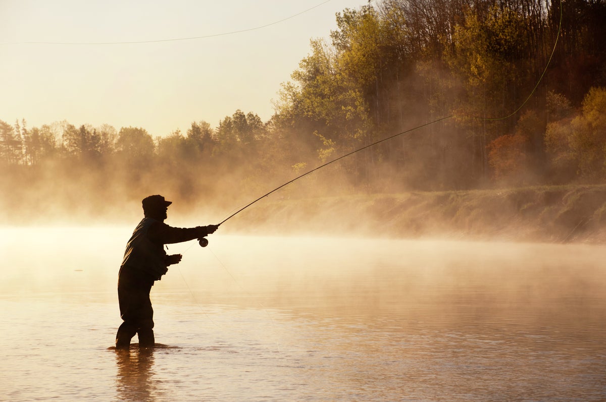 shutterstock 165430076 fishing fly fisherman fly casting in misty river in the woods