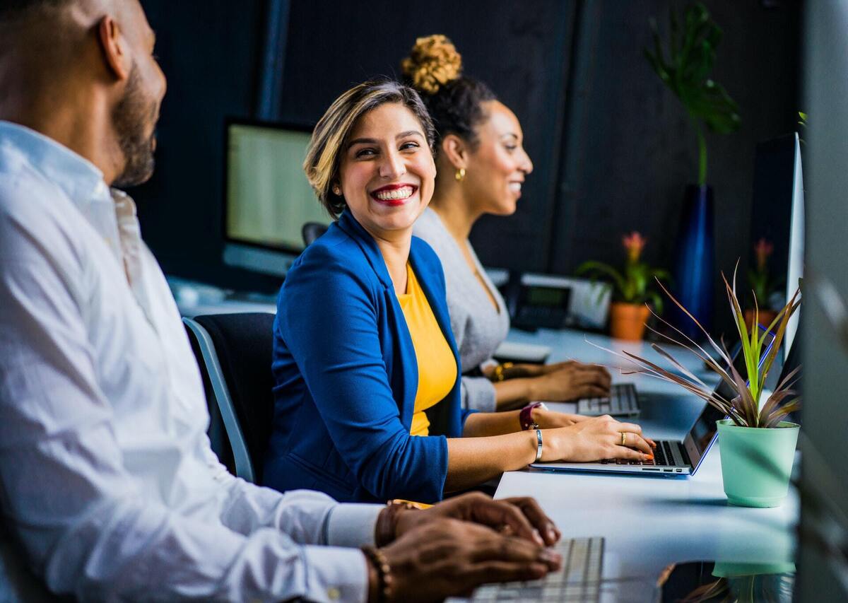 information technology and project management smiling happy workers by jopwell via pexels