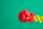 Knockout, sucker punch. Red boxing glove on green background.