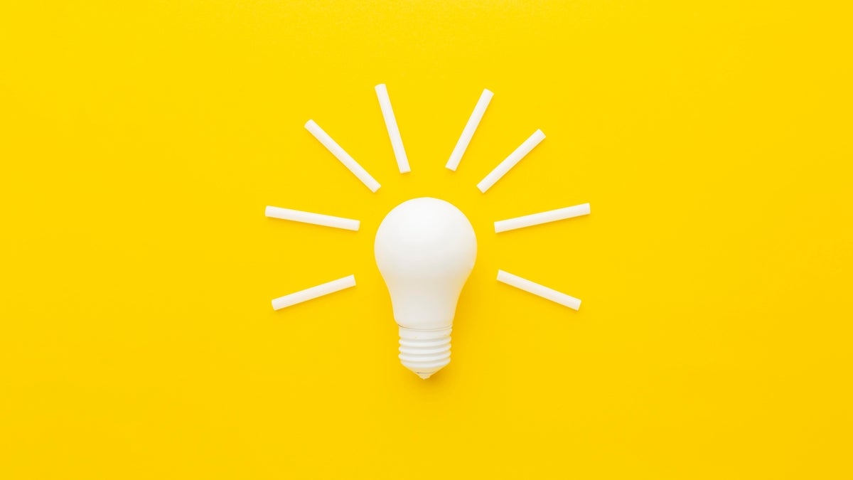 shutterstock 2408848757 white light bulb and white sticks of chalk on bright yellow background