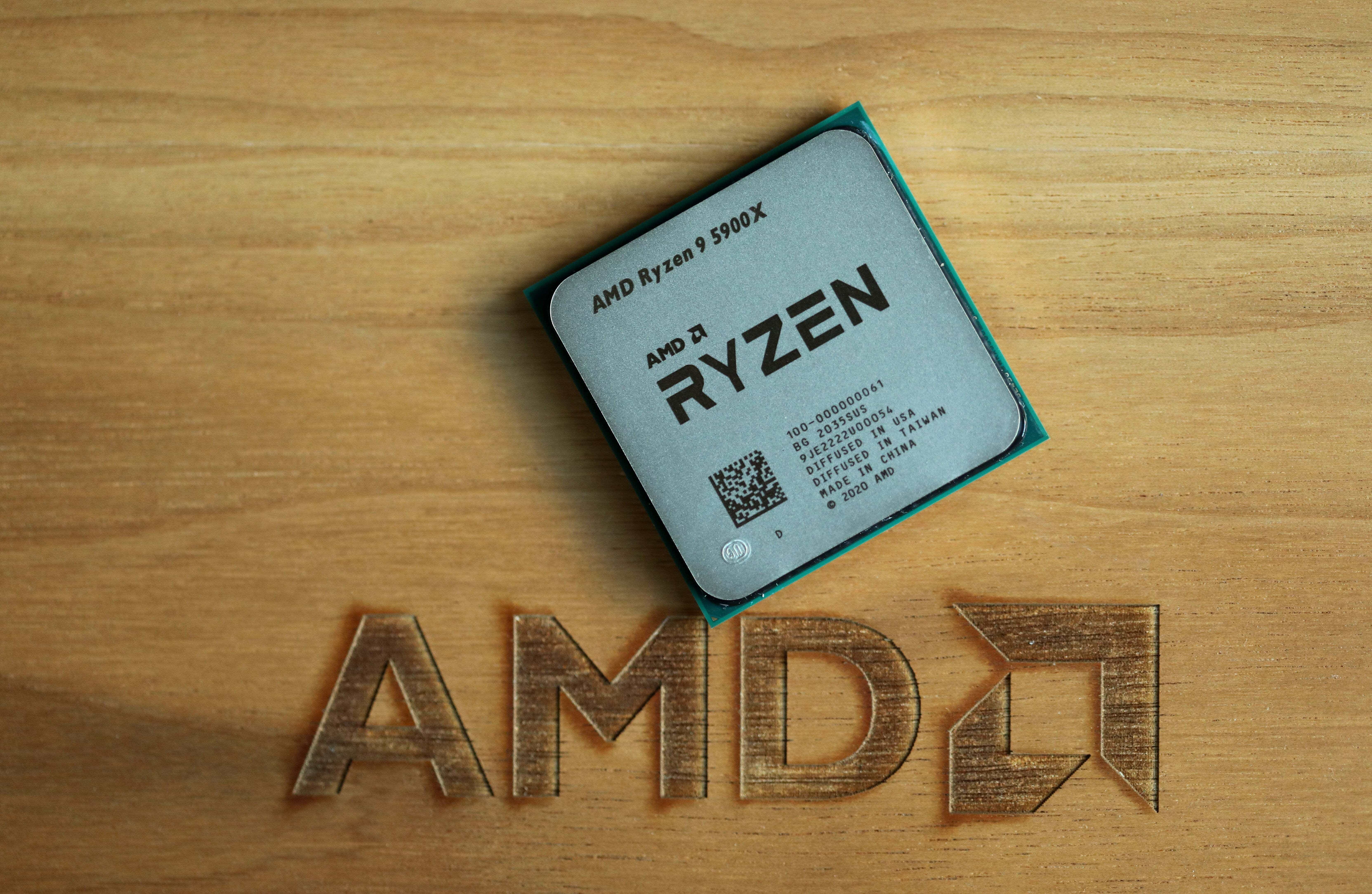 AMD Ryzen 9 5900X on a wood background with AMD logo burned into the wood